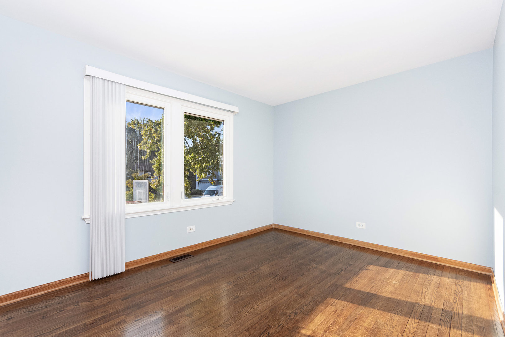1635 Chippendale Road Hoffman Estates, IL 60169 - Photo 11 of 27 an empty room with wooden floor and windows