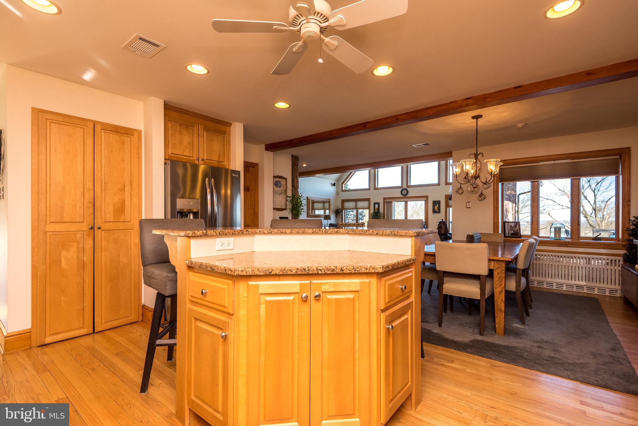 791 Temple Road Pottstown, PA 19465 - Photo 23 of 82 a kitchen with stainless steel appliances kitchen island granite countertop a table chairs and a refrigerator