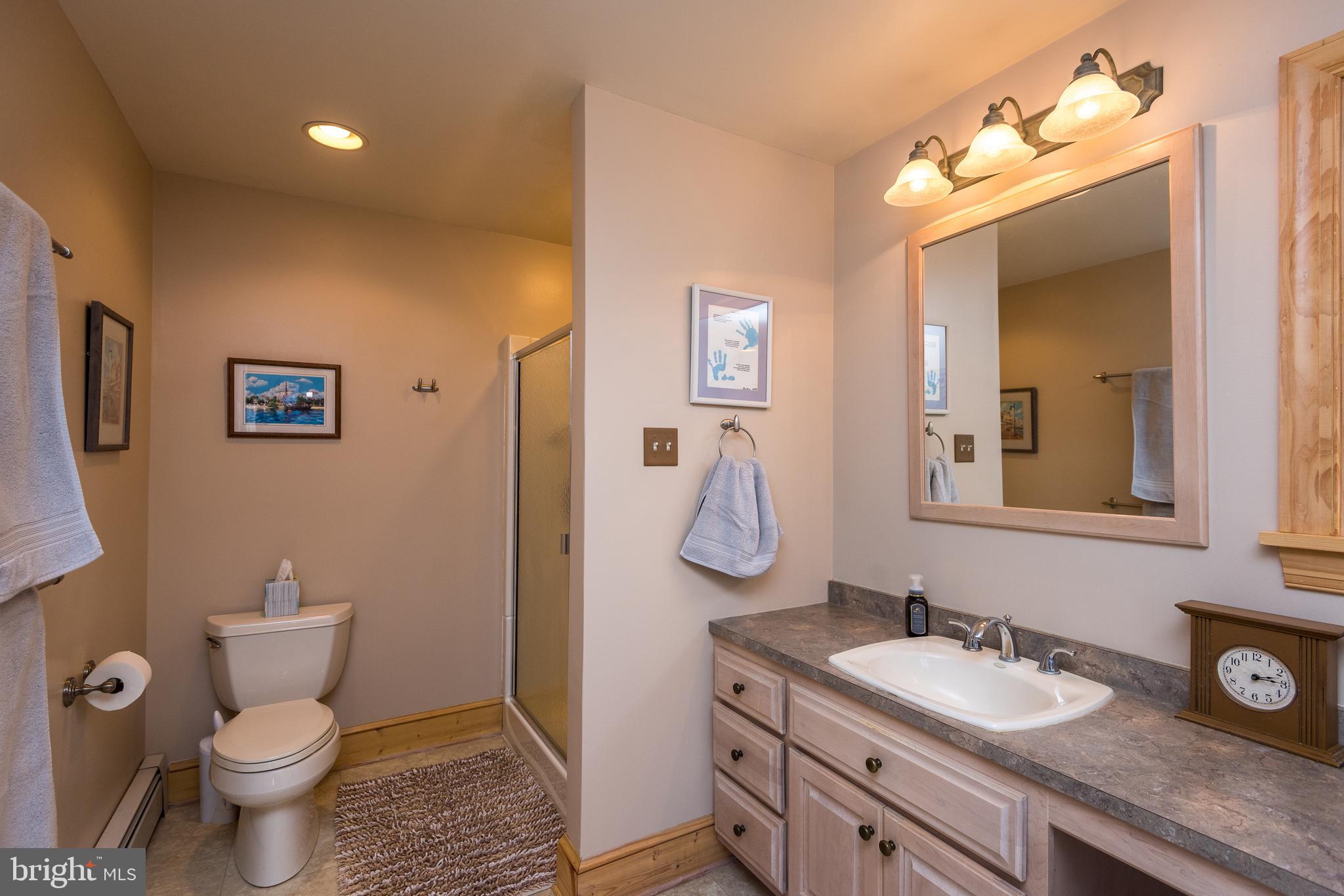 791 Temple Road Pottstown, PA 19465 - Photo 36 of 82 a bathroom with a granite countertop sink mirror vanity and toilet