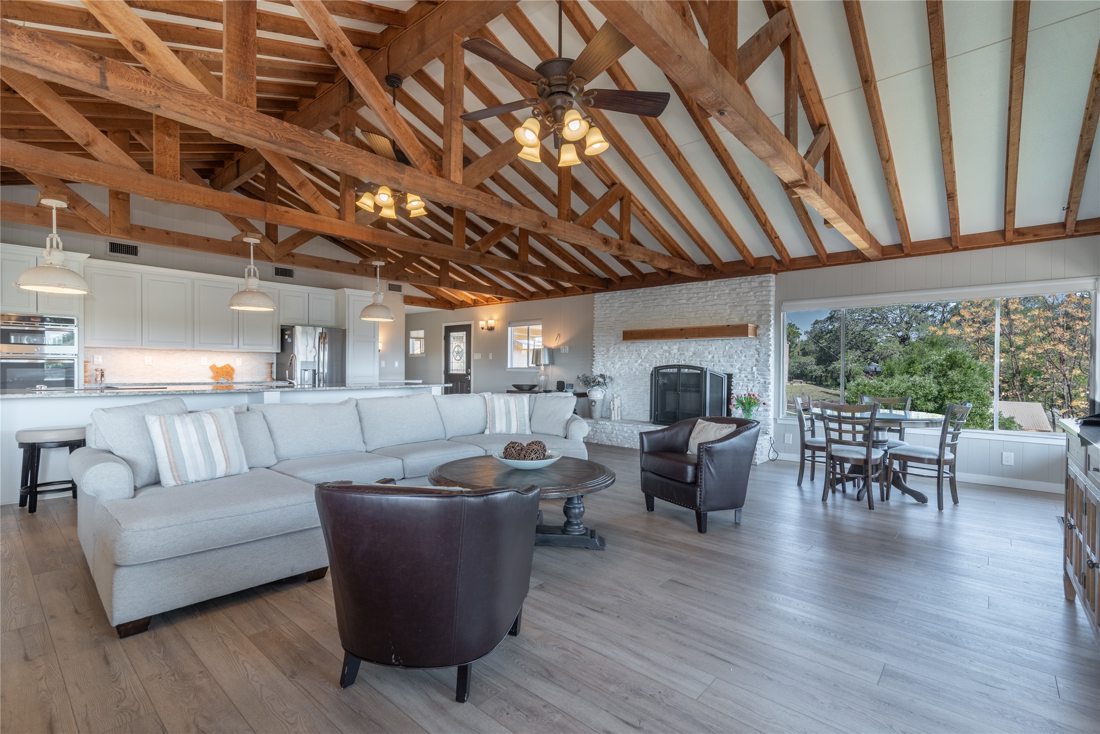 3807 Boat Dock Road Lago Vista, TX 78645 - Photo 7 of 37 A spacious, open-concept interior features soaring vaulted ceilings with exposed beams and a captivating view.