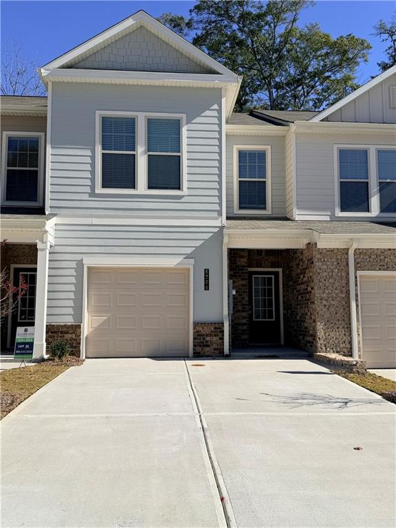 6206 Ripple Way, Unit 89 Atlanta, GA 30349 - Photo 1 of 26 a front view of a house with yard