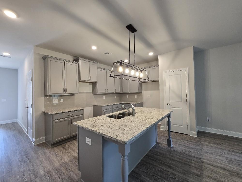 6206 Ripple Way, Unit 89 Atlanta, GA 30349 - Photo 12 of 26 a kitchen with a sink a counter top space and stainless steel appliances
