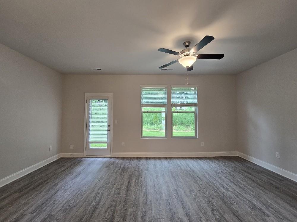 6206 Ripple Way, Unit 89 Atlanta, GA 30349 - Photo 13 of 26 an empty room with wooden floor and windows