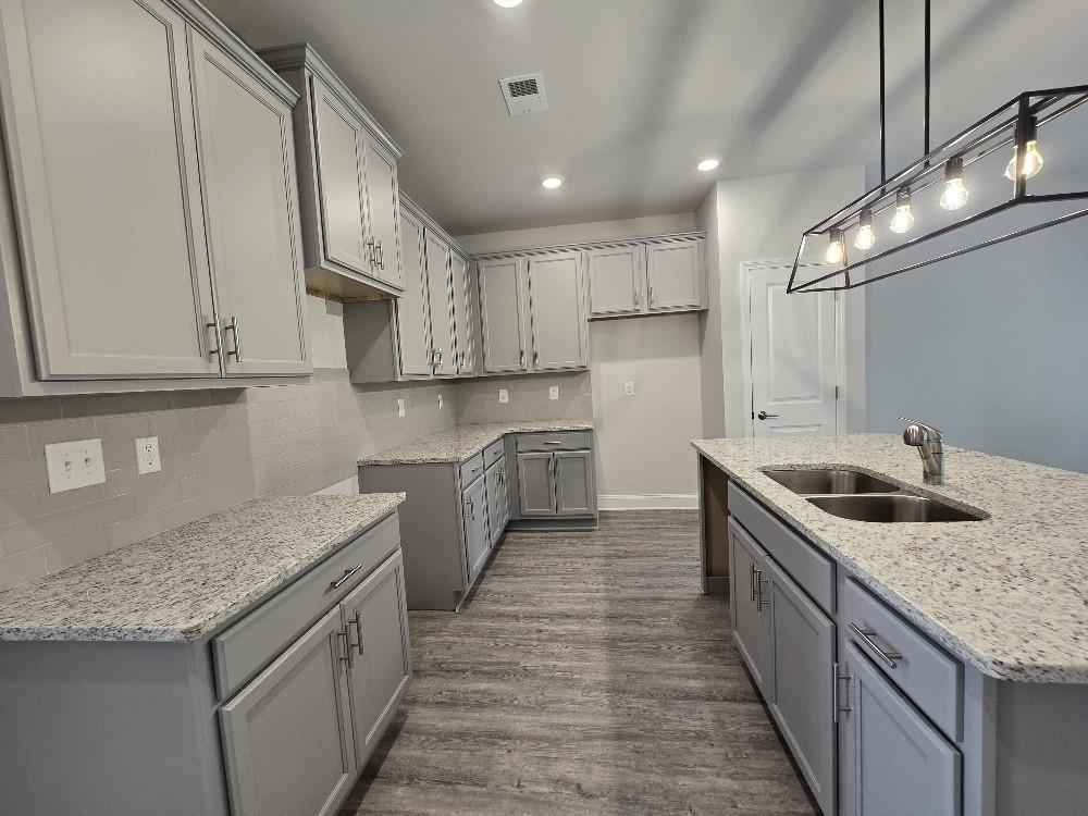 6206 Ripple Way, Unit 89 Atlanta, GA 30349 - Photo 4 of 26 a kitchen with stainless steel appliances granite countertop a sink stove and cabinets