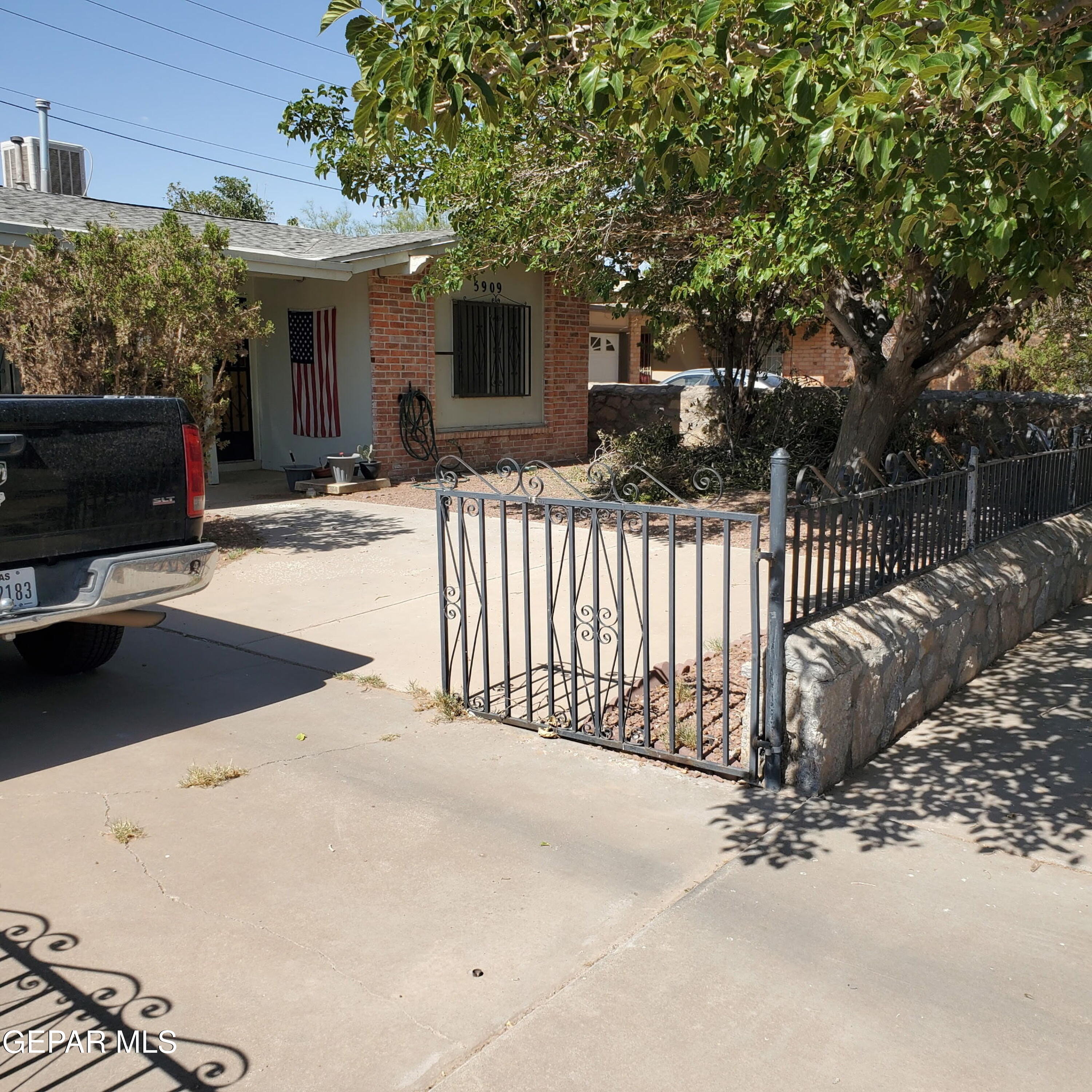 a view of a house with a bench in a patio