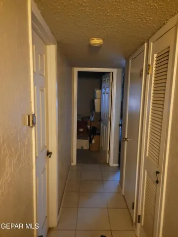 a view of a hallway with wooden shelves