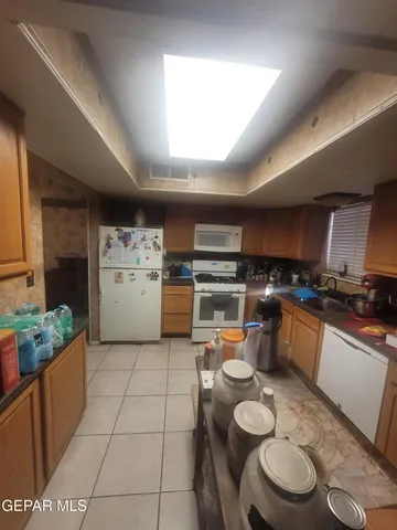 a kitchen with a sink a stove and a refrigerator