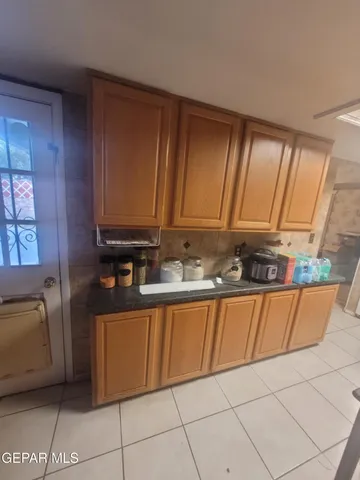 a kitchen with granite countertop a sink and a stove