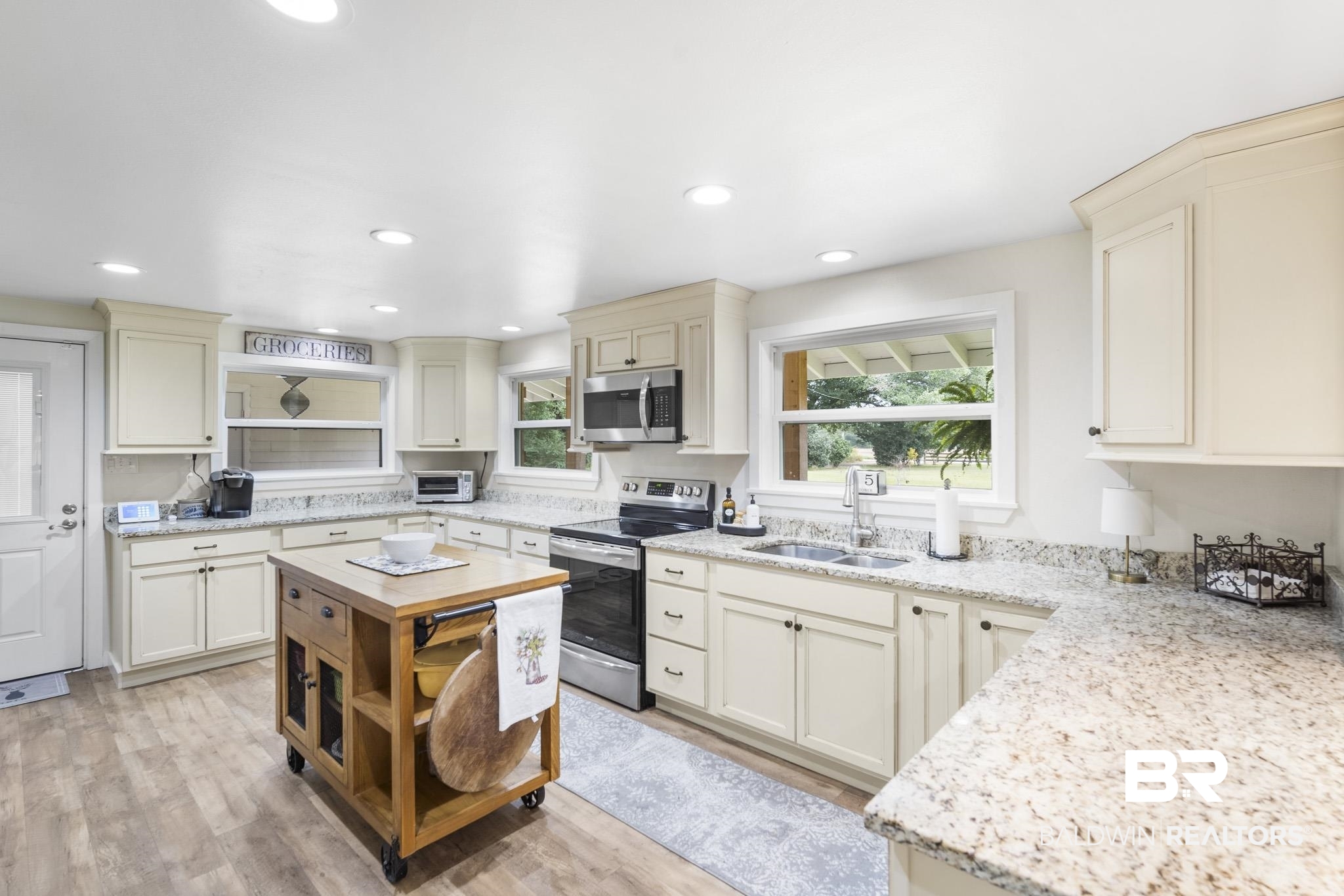 16475 River Park Road Fairhope, AL 36532 - Photo 4 of 37 Kitchen with sink, light hardwood / wood-style floors, appliances with stainless steel finishes, and a wealth of natural light