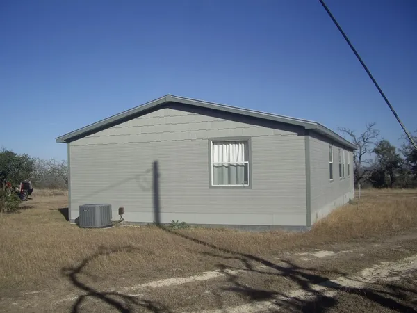 a backyard of house with a yard