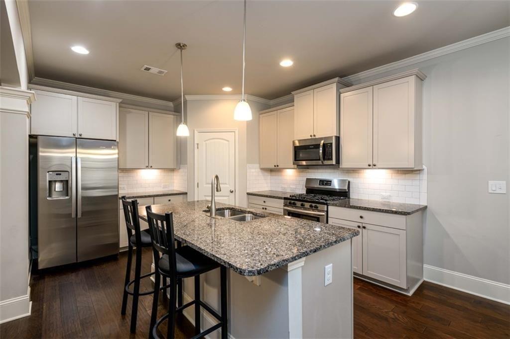 6622 Trailblazer Road Flowery Branch, GA 30542 - Photo 11 of 51 a kitchen with a stove a refrigerator and a sink