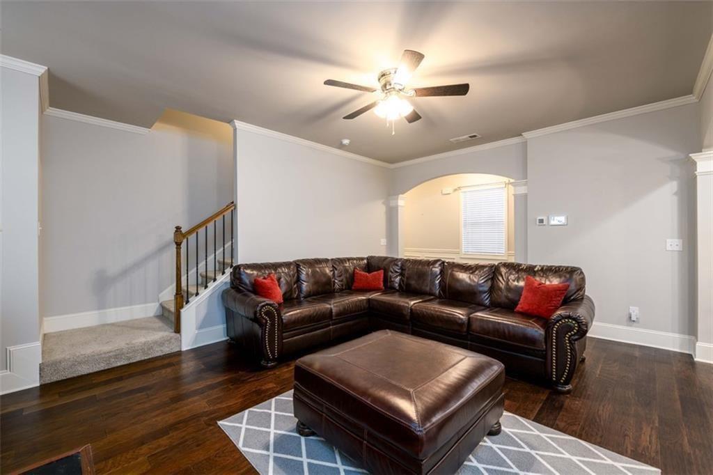 6622 Trailblazer Road Flowery Branch, GA 30542 - Photo 19 of 51 a living room with furniture a ceiling fan and a rug