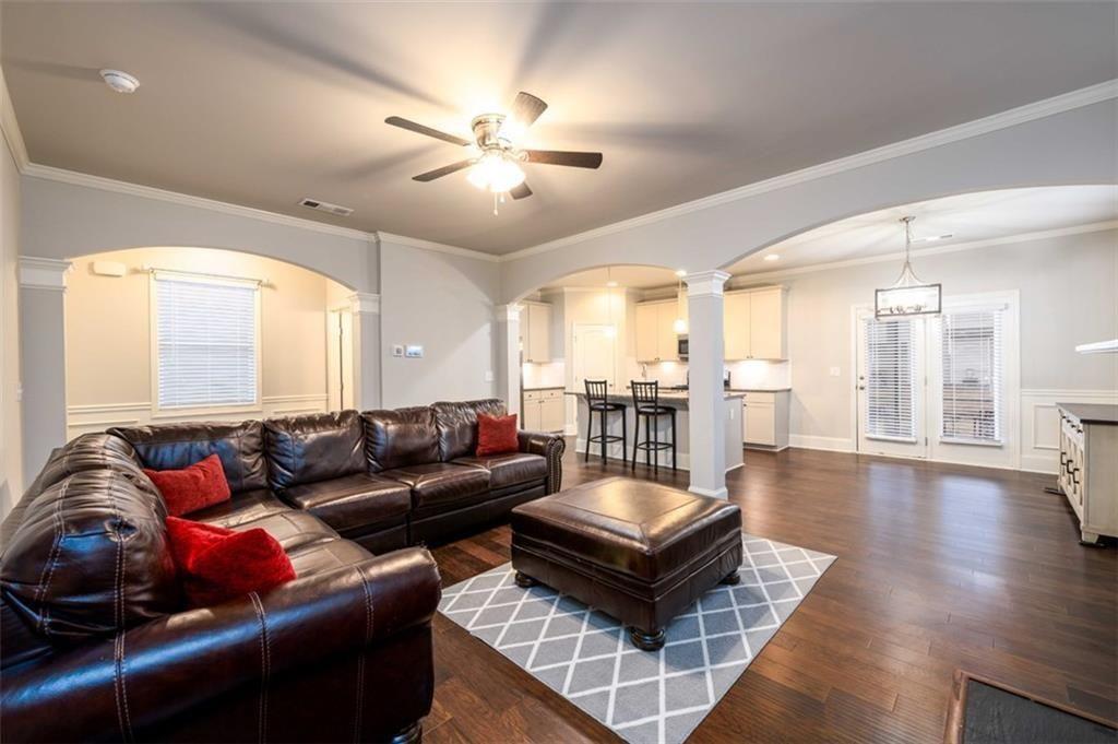 6622 Trailblazer Road Flowery Branch, GA 30542 - Photo 20 of 51 a living room with furniture and a chandelier