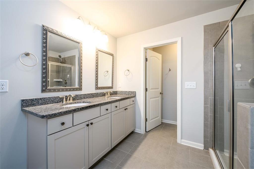 6622 Trailblazer Road Flowery Branch, GA 30542 - Photo 25 of 51 a bathroom with a granite countertop sink and a mirror