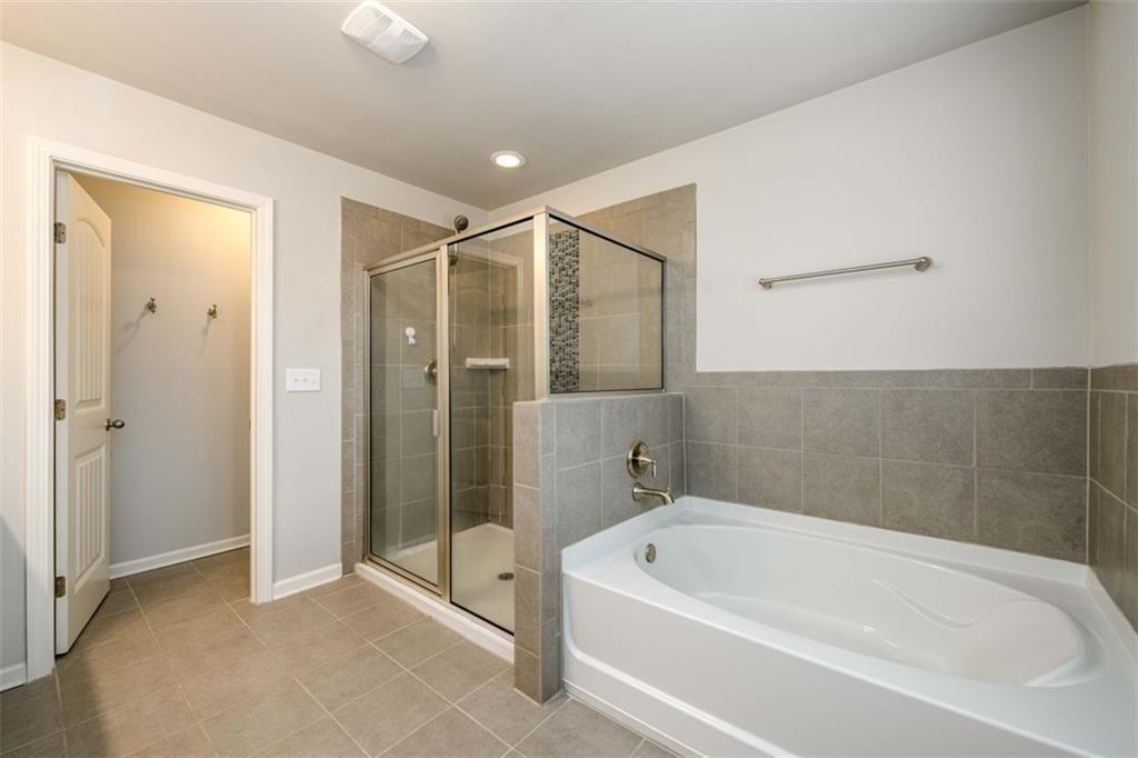 6622 Trailblazer Road Flowery Branch, GA 30542 - Photo 26 of 51 a bathroom with a tub a shower and view