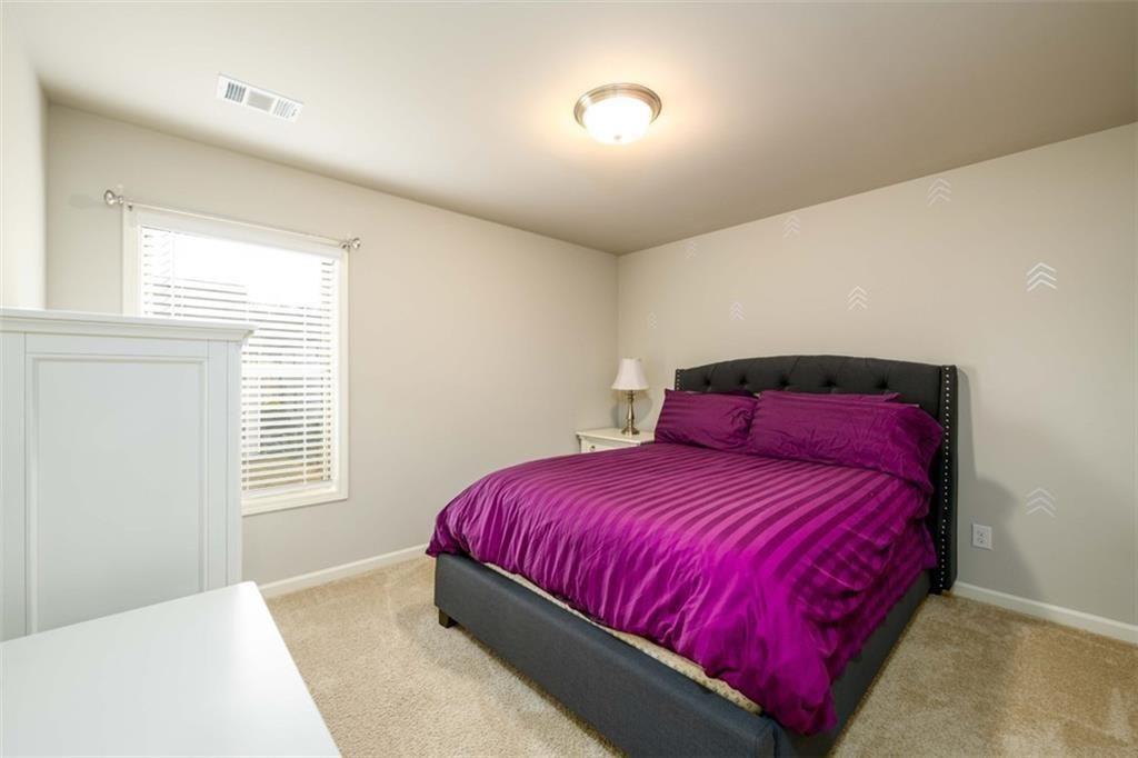 6622 Trailblazer Road Flowery Branch, GA 30542 - Photo 27 of 51 a bedroom with a bed and a window