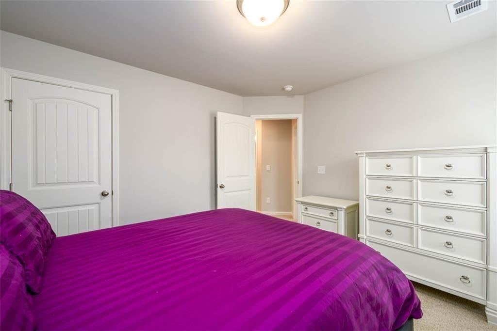 6622 Trailblazer Road Flowery Branch, GA 30542 - Photo 28 of 51 a bedroom with a large bed and a closet