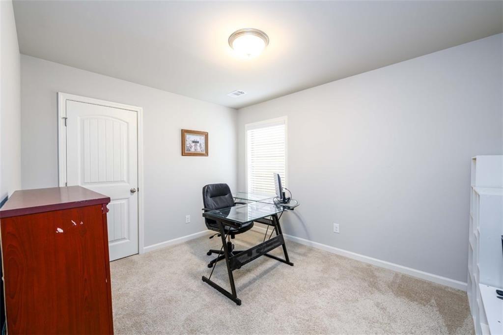 6622 Trailblazer Road Flowery Branch, GA 30542 - Photo 31 of 51 a view of a workspace with furniture and a window