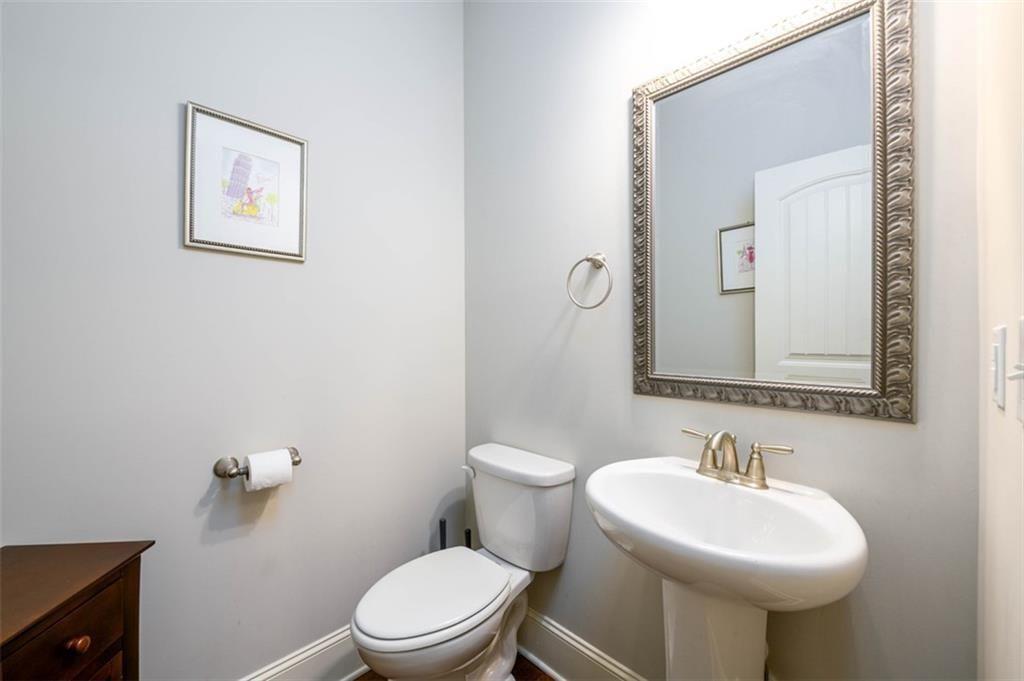 6622 Trailblazer Road Flowery Branch, GA 30542 - Photo 7 of 51 a bathroom with a toilet sink and mirror