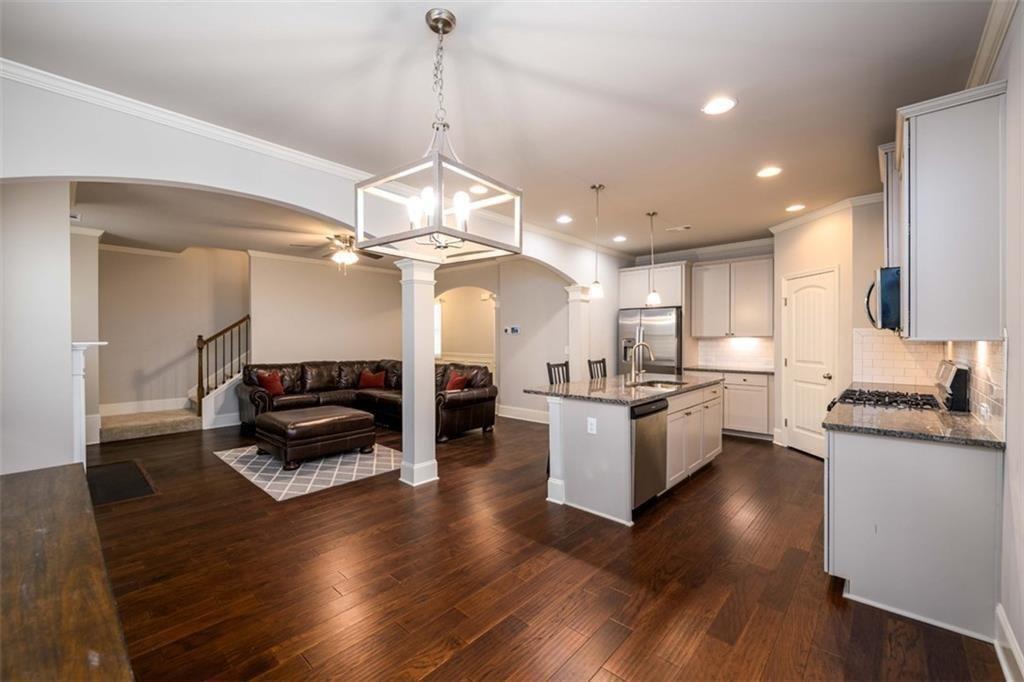 6622 Trailblazer Road Flowery Branch, GA 30542 - Photo 10 of 51 a kitchen with granite countertop a stove and a wooden floor