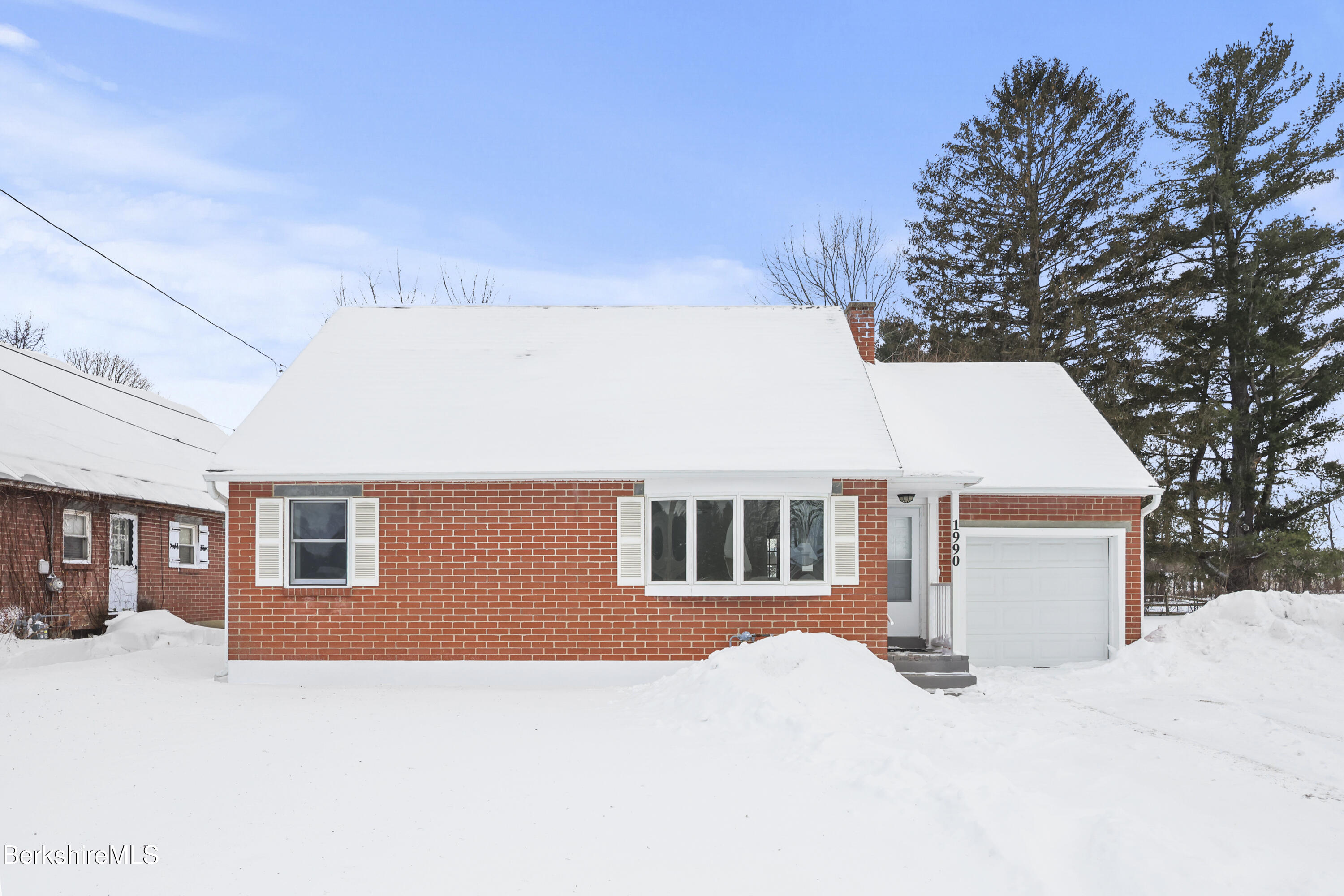 a view of a house with a snow in the yard