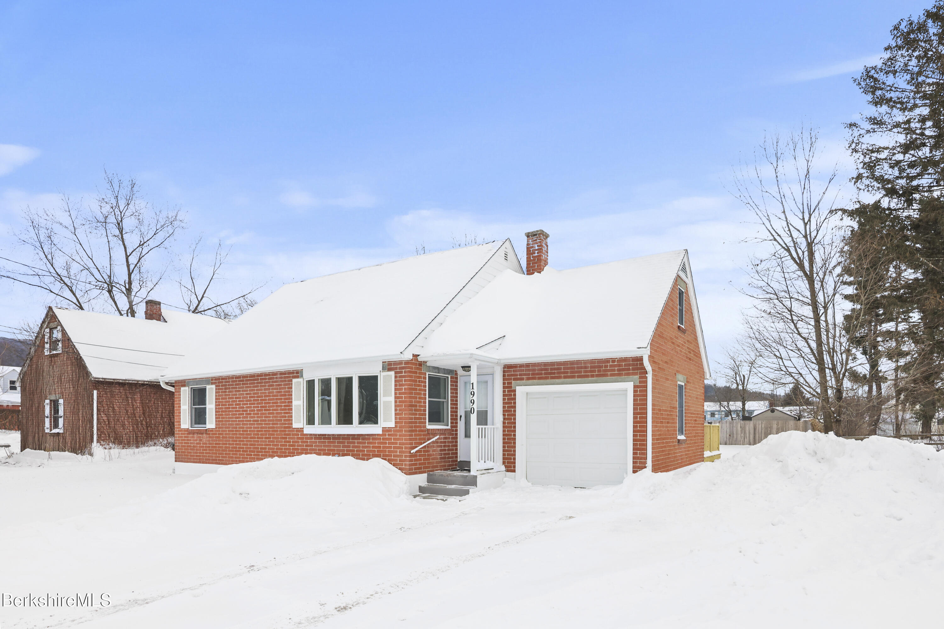 1990 East Street Pittsfield, MA 01201 - Photo 2 of 33 a front view of a house with a yard covered in snow