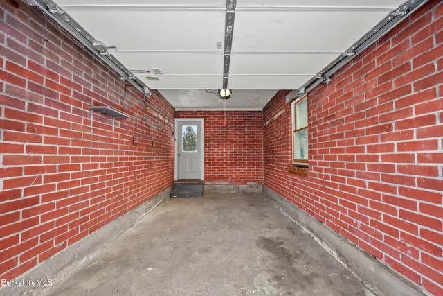 a view of a backyard with brick walls