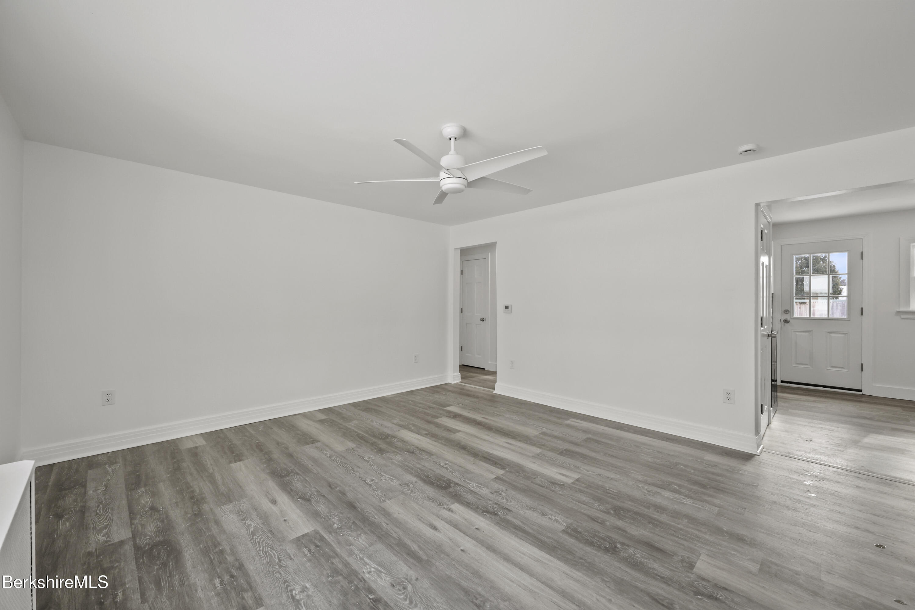 1990 East Street Pittsfield, MA 01201 - Photo 4 of 33 an empty room with wooden floor and ceiling fan