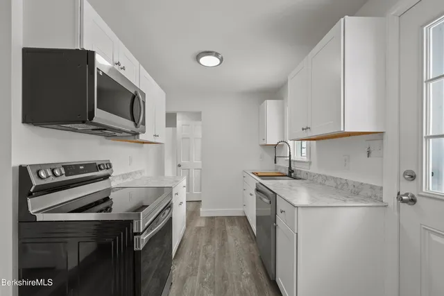 a kitchen with a sink stove and microwave