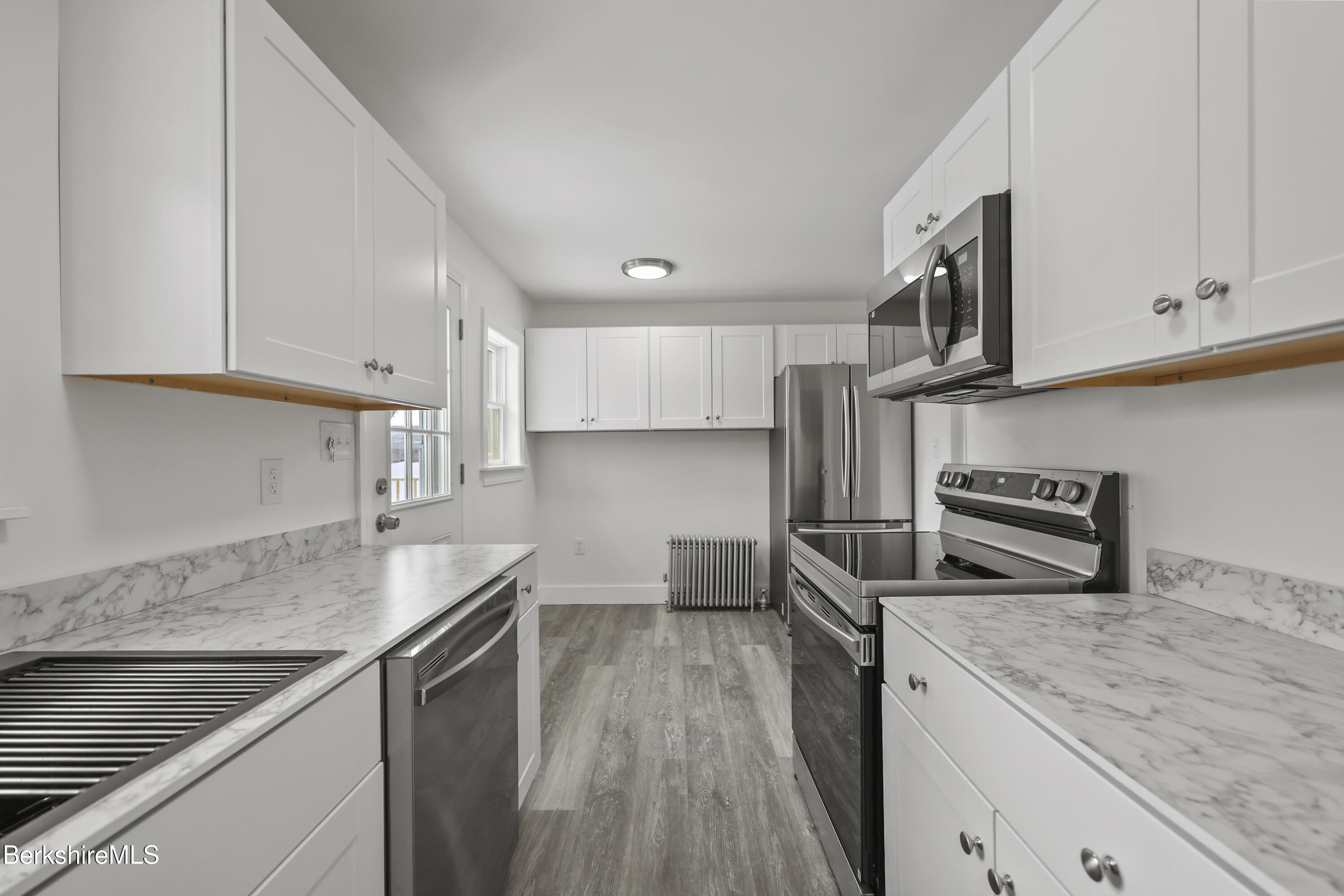 1990 East Street Pittsfield, MA 01201 - Photo 10 of 33 a kitchen with granite countertop a sink a stove and cabinets
