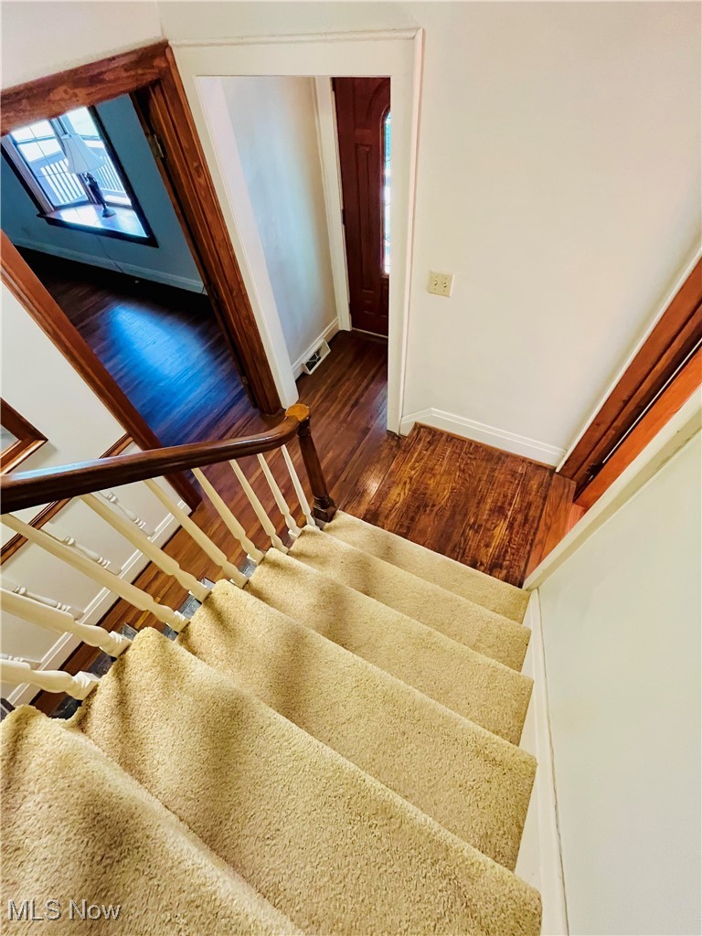 6543 North Ridge Road East Geneva, OH 44041 - Photo 8 of 49 Stairway featuring hardwood / wood-style floors