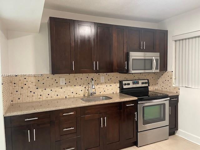 219 Southwest 9th Avenue, Unit 2 Miami, FL 33130 - Photo 11 of 28 a kitchen with granite countertop white cabinets and stainless steel appliances