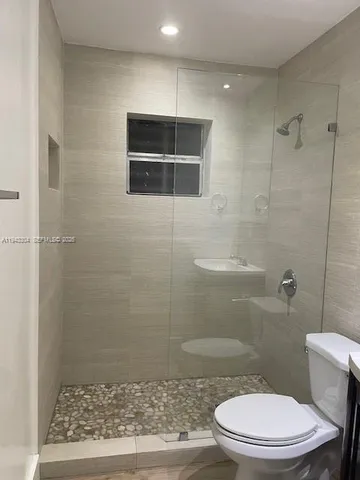 a bathroom with a toilet and a shower