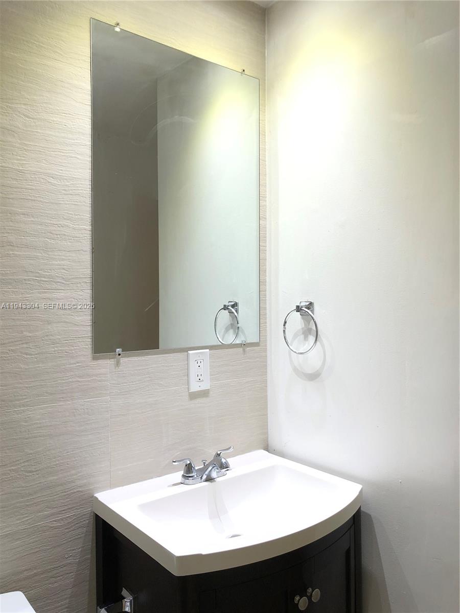 219 Southwest 9th Avenue, Unit 2 Miami, FL 33130 - Photo 18 of 28 a bathroom with a sink and a mirror