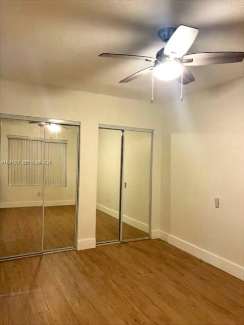 219 Southwest 9th Avenue, Unit 2 Miami, FL 33130 - Photo 25 of 28 an empty room with wooden floor and fan
