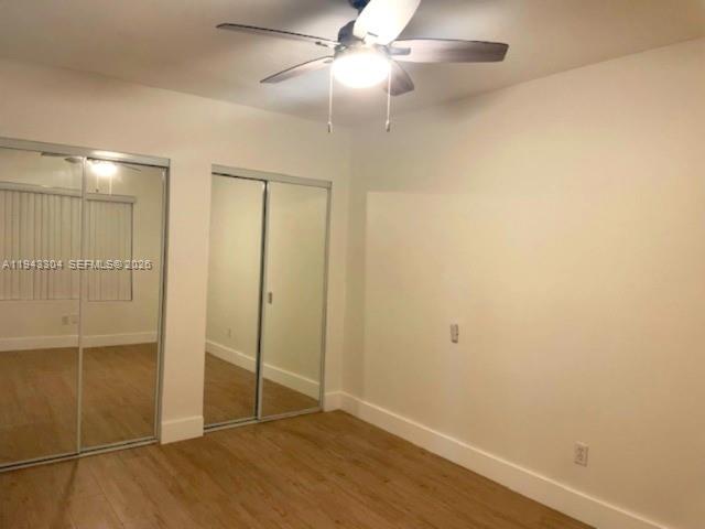 219 Southwest 9th Avenue, Unit 2 Miami, FL 33130 - Photo 26 of 28 an empty room with wooden floor fan and windows