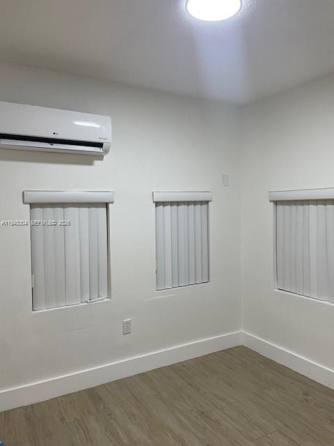 219 Southwest 9th Avenue, Unit 2 Miami, FL 33130 - Photo 27 of 28 a view of an empty room with wooden floor and a window
