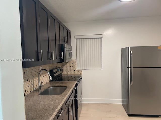 219 Southwest 9th Avenue, Unit 2 Miami, FL 33130 - Photo 4 of 28 a kitchen with granite countertop a refrigerator and a sink