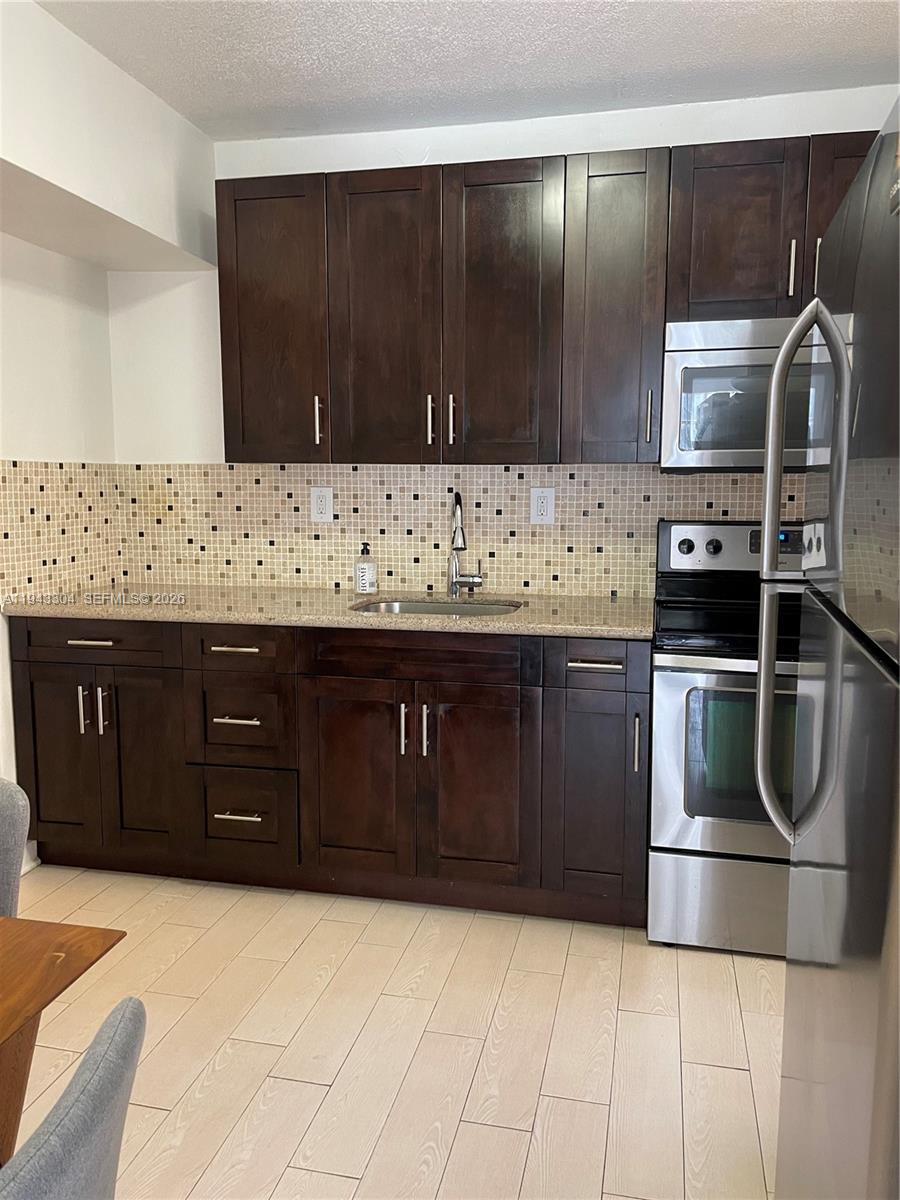 219 Southwest 9th Avenue, Unit 2 Miami, FL 33130 - Photo 8 of 28 a kitchen with stainless steel appliances and cabinets