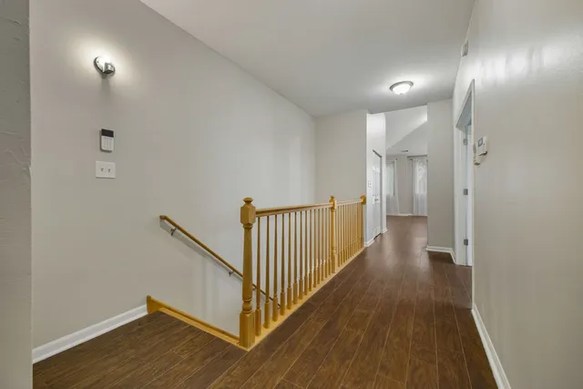 a view of a hallway with wooden floor