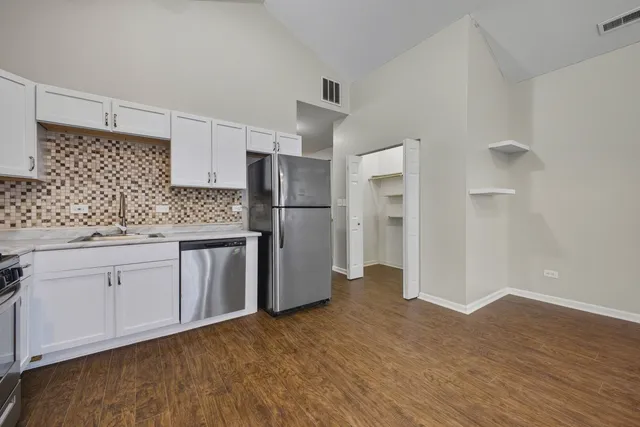 a kitchen with stainless steel appliances a refrigerator sink and cabinets