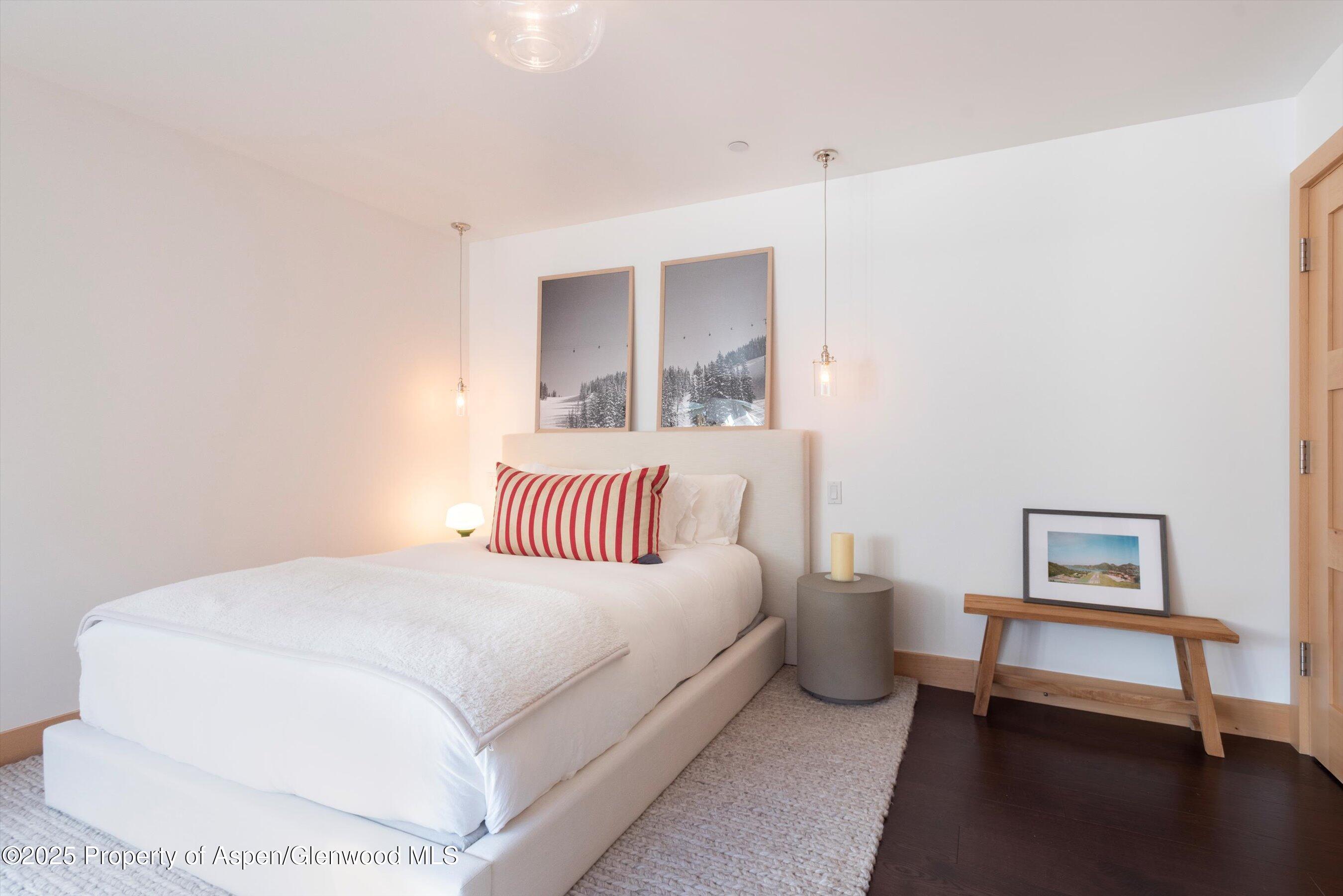 6770 Castle Creek Road Aspen, CO 81612 - Photo 28 of 53 a bed room with a bed and a painting on the wall