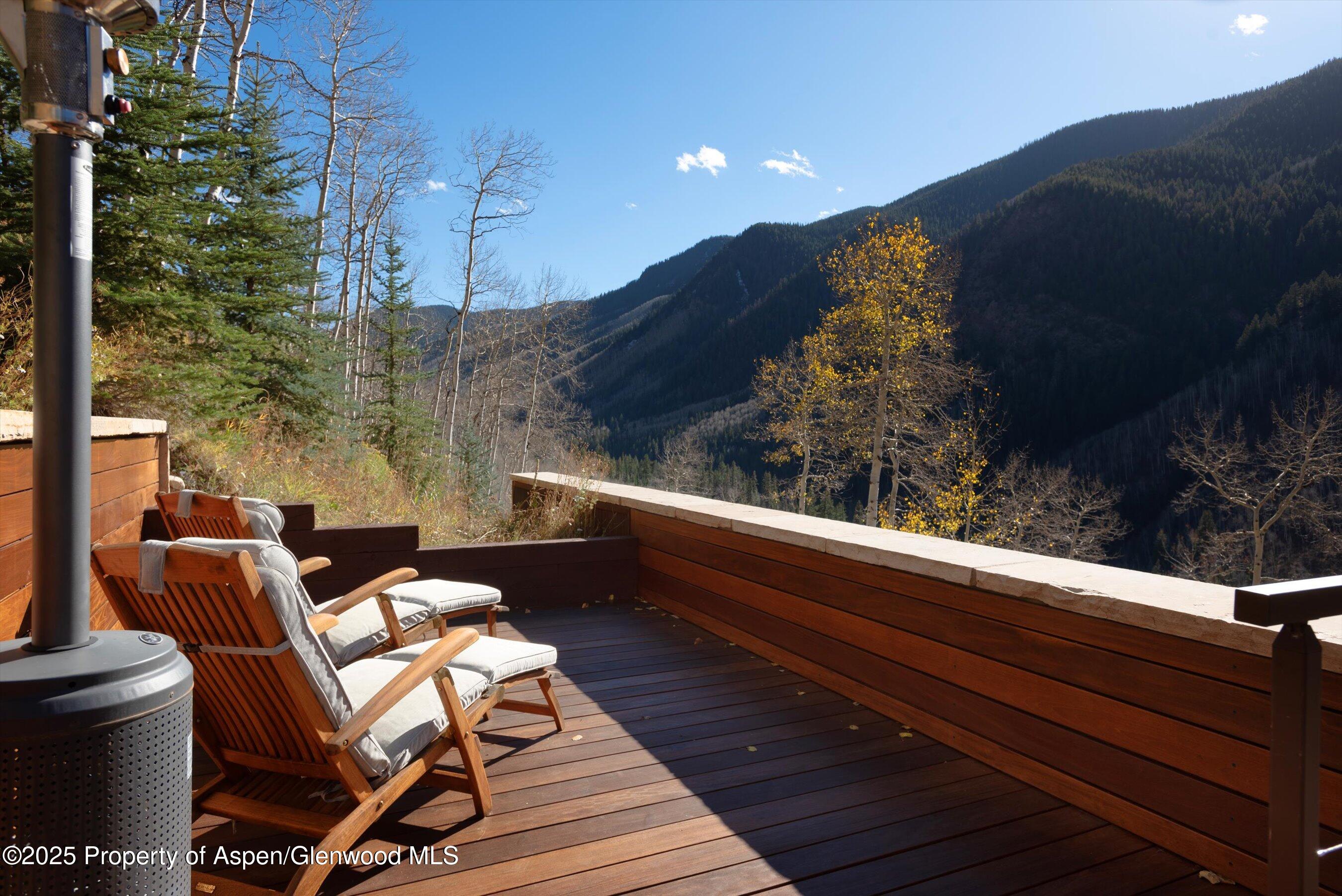 6770 Castle Creek Road Aspen, CO 81612 - Photo 50 of 53 a balcony with wooden floor table and chairs