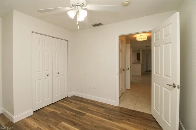 wooden floor in an empty room with a mirror
