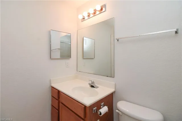 a bathroom with a sink toilet and mirror