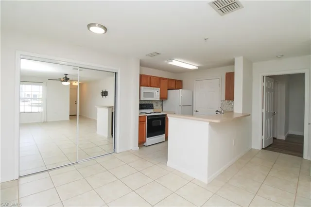 a view of a kitchen with cabinets and stainless steel appliances