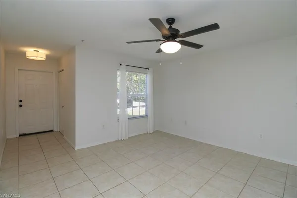 a view of a livingroom with a ceiling fan and window