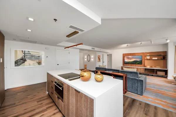 a kitchen with stainless steel appliances a stove a sink and a microwave