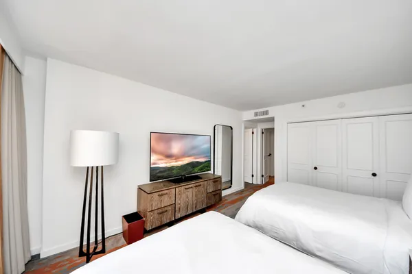 a bedroom with furniture and a flat screen tv
