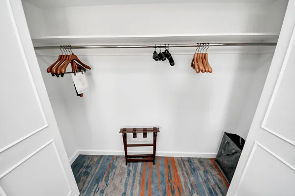 a view of walk in closet with clothes and shoes